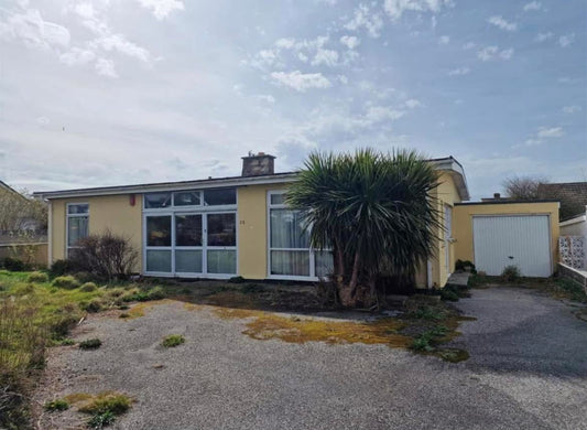1964 Mid-Century bungalow in Newquay before renovation with original frontage, large windows and mature palm tree