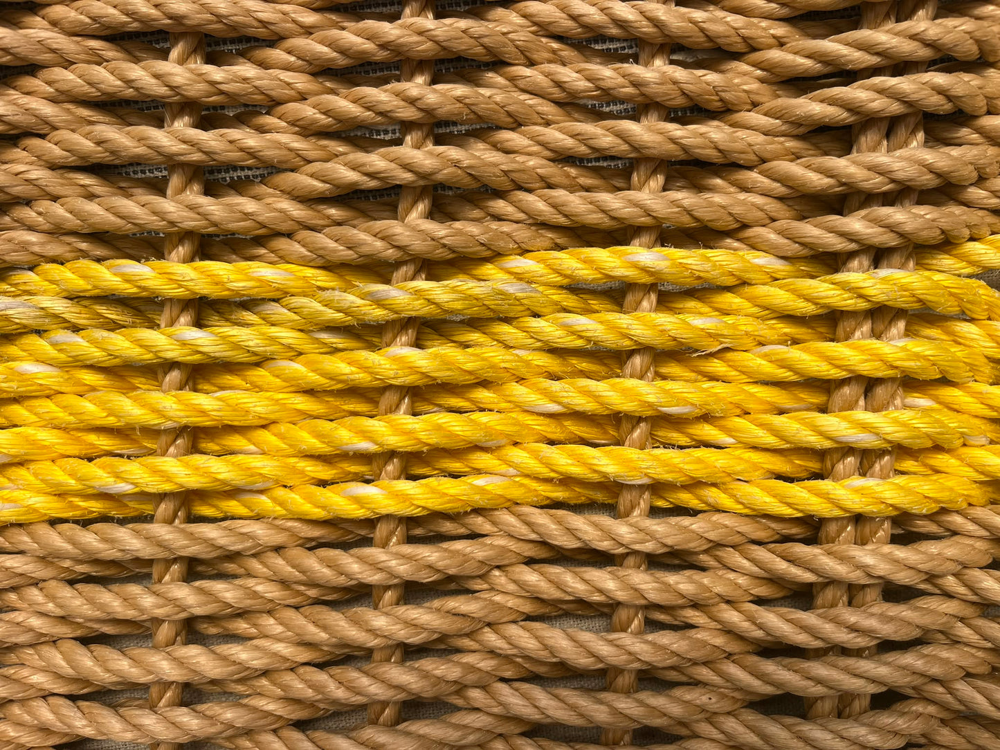 Close-up of reclaimed yellow fishing rope woven into handcrafted Cornish door mat