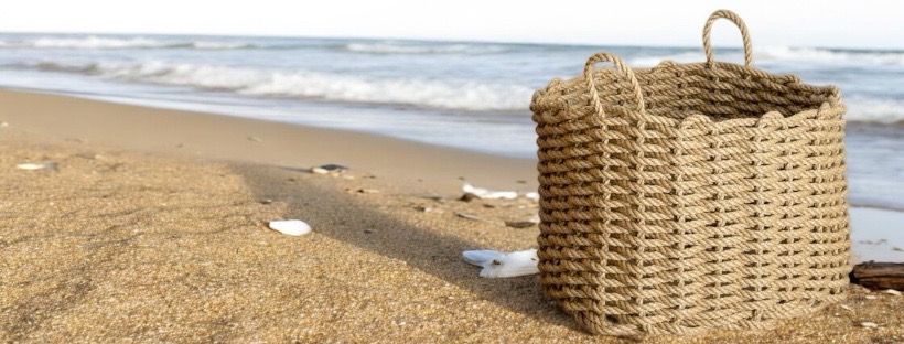 Handwoven rope basket from Lovan Cornwall, on a beach in Cornwall.